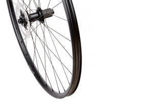 <h1>Rims</h1><i>A strong and lightweight 6066-T6 heat-treated rim features an asymmetric shape which is inverted from front to rear to provide balanced higher spoke tensions meaning your spokes stay tight for the long term. The rim profile is disc specific which allows higher-strength to weight as no reinforcement is required for a braking surface. The extra wide rim at 29mm (25mm internal) which creates a great tyre profile with wider 35-50mm tyres, giving excellent grip and lower rolling resistance.</i>